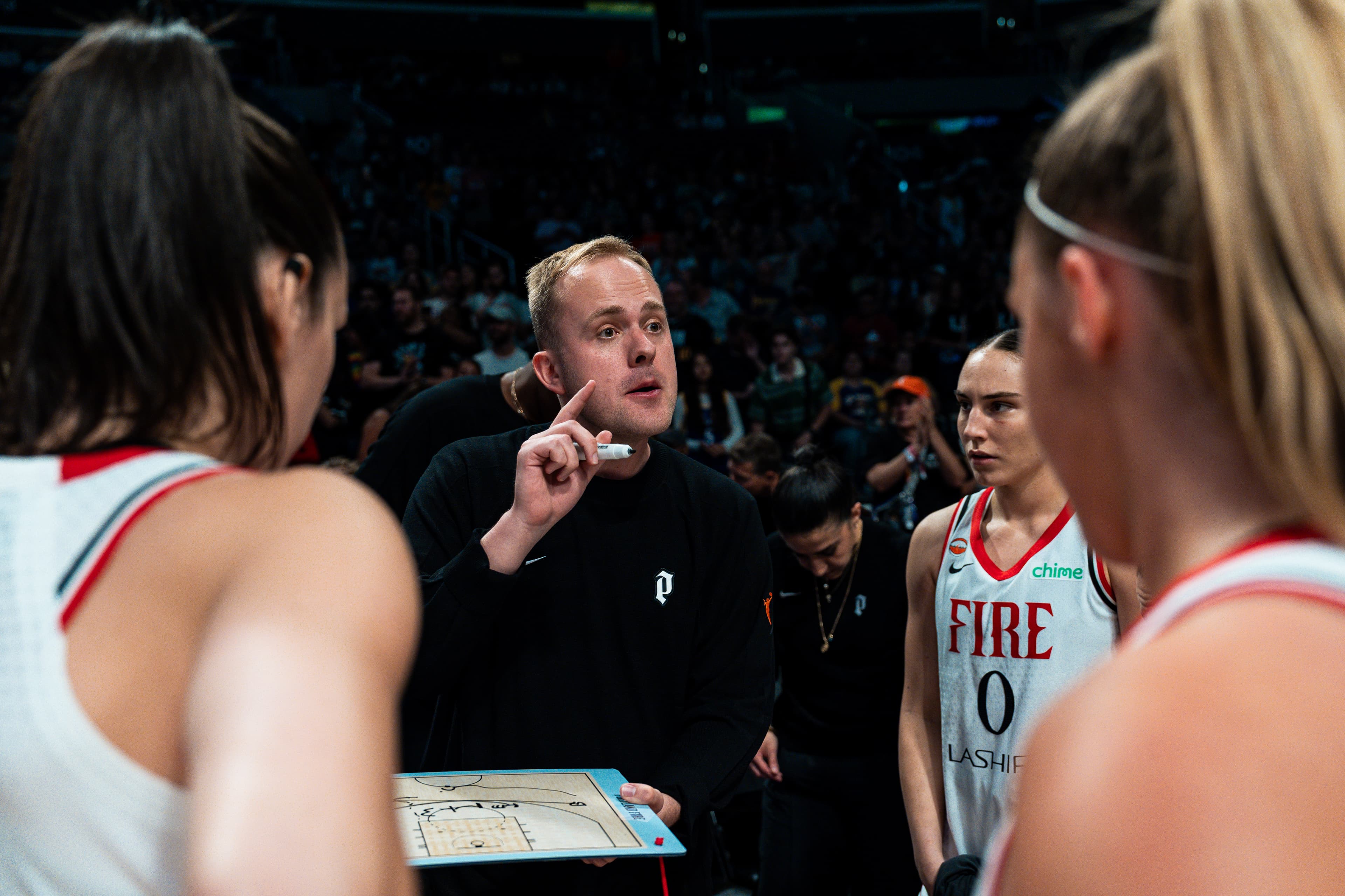 Alex Sarama coaching in a Portland Fire timeout huddle