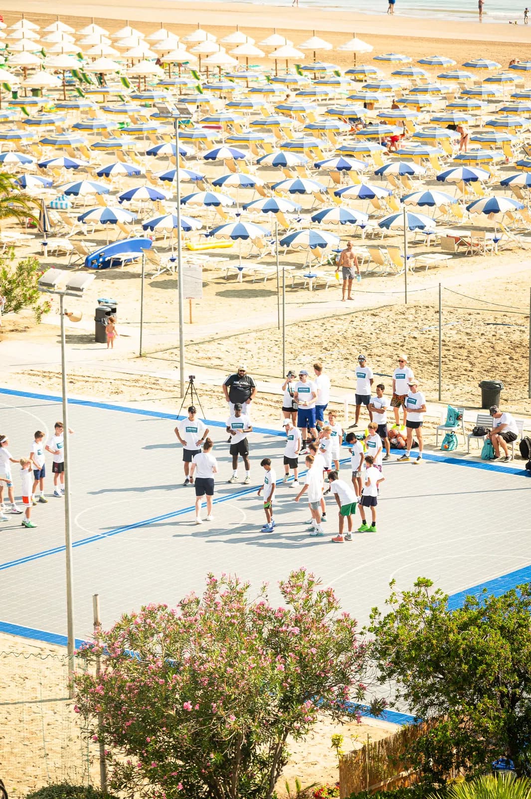 Players practicing on the outdoor basketball court beside the beach at Roseto