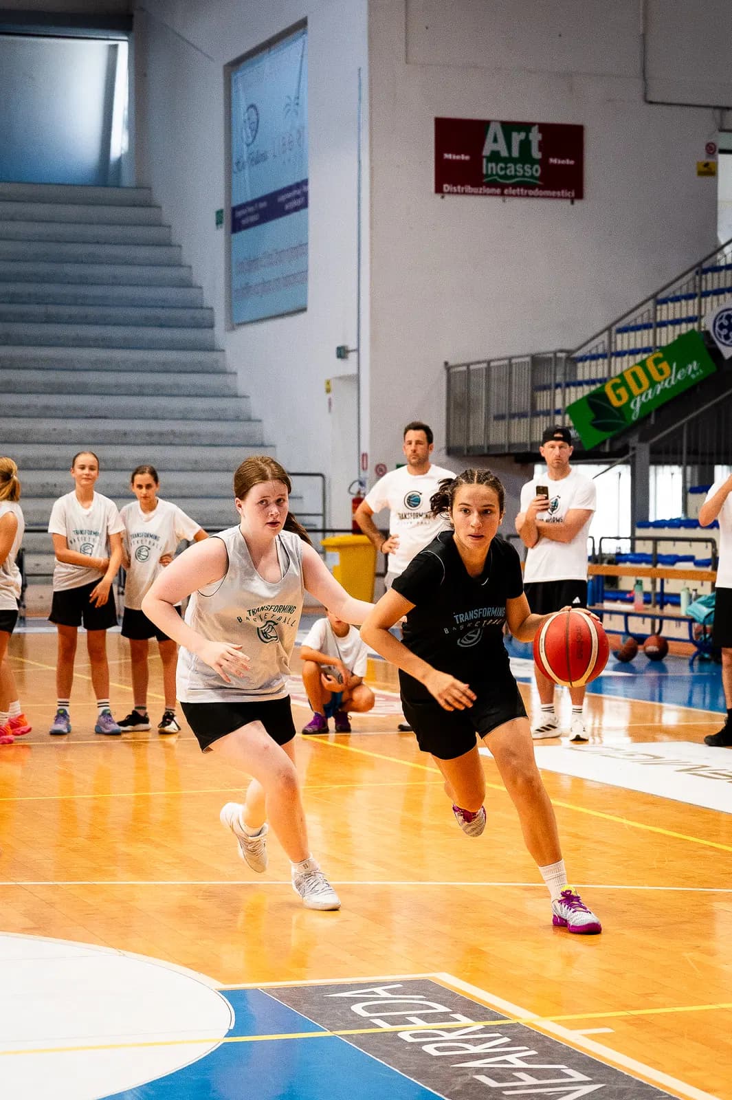 Players waiting in lines while a live one-on-one plays out during an organized practice