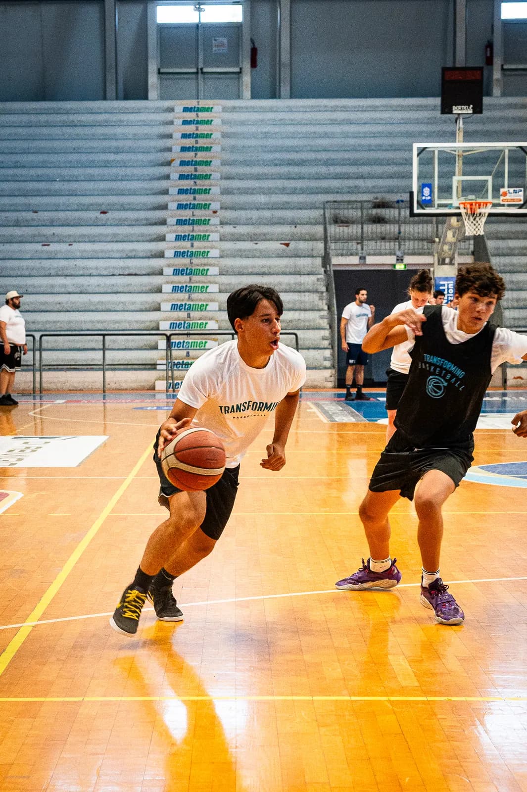 Two young players competing one-on-one at the Transforming Basketball camp in Roseto