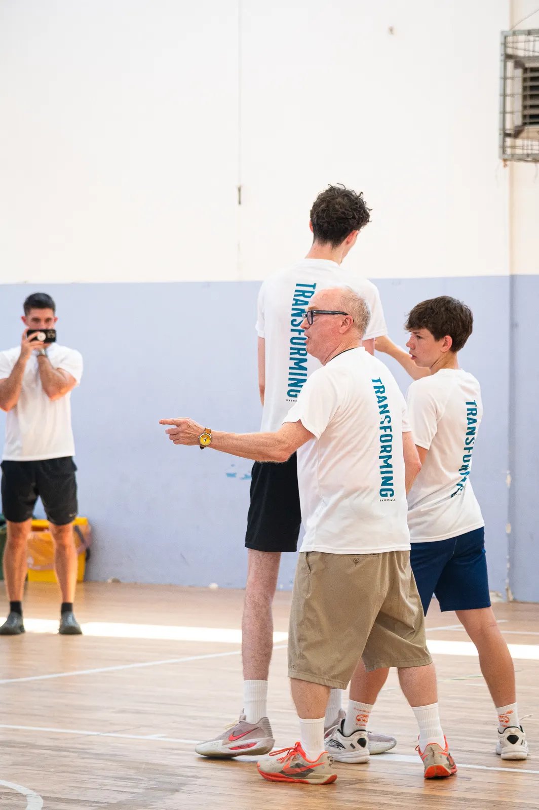 A coach directing a group of players on court at the 2026 Transforming Basketball camp in Roseto