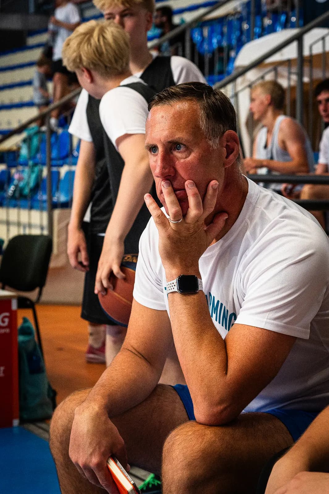 A coach watching play closely from the sideline at the 2026 Transforming Basketball camp in Roseto