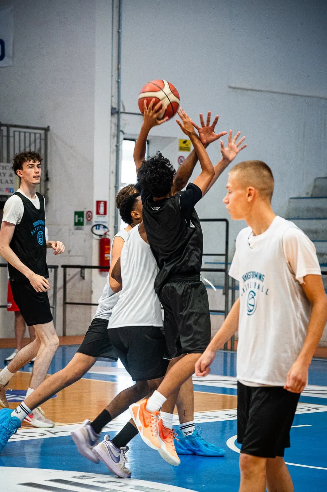 A defender leaping to contest a jump shot during a game at the 2026 Transforming Basketball camp in Roseto
