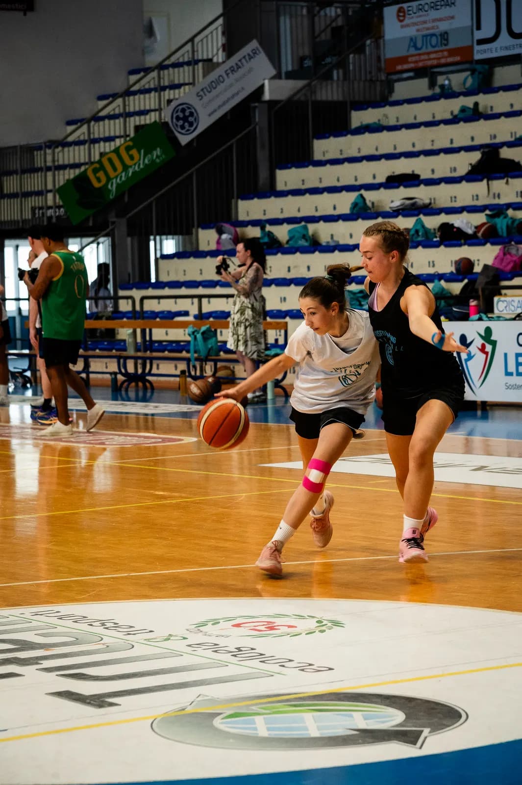 A ball-handler driving past a defender during a live game at the 2026 Transforming Basketball camp in Roseto