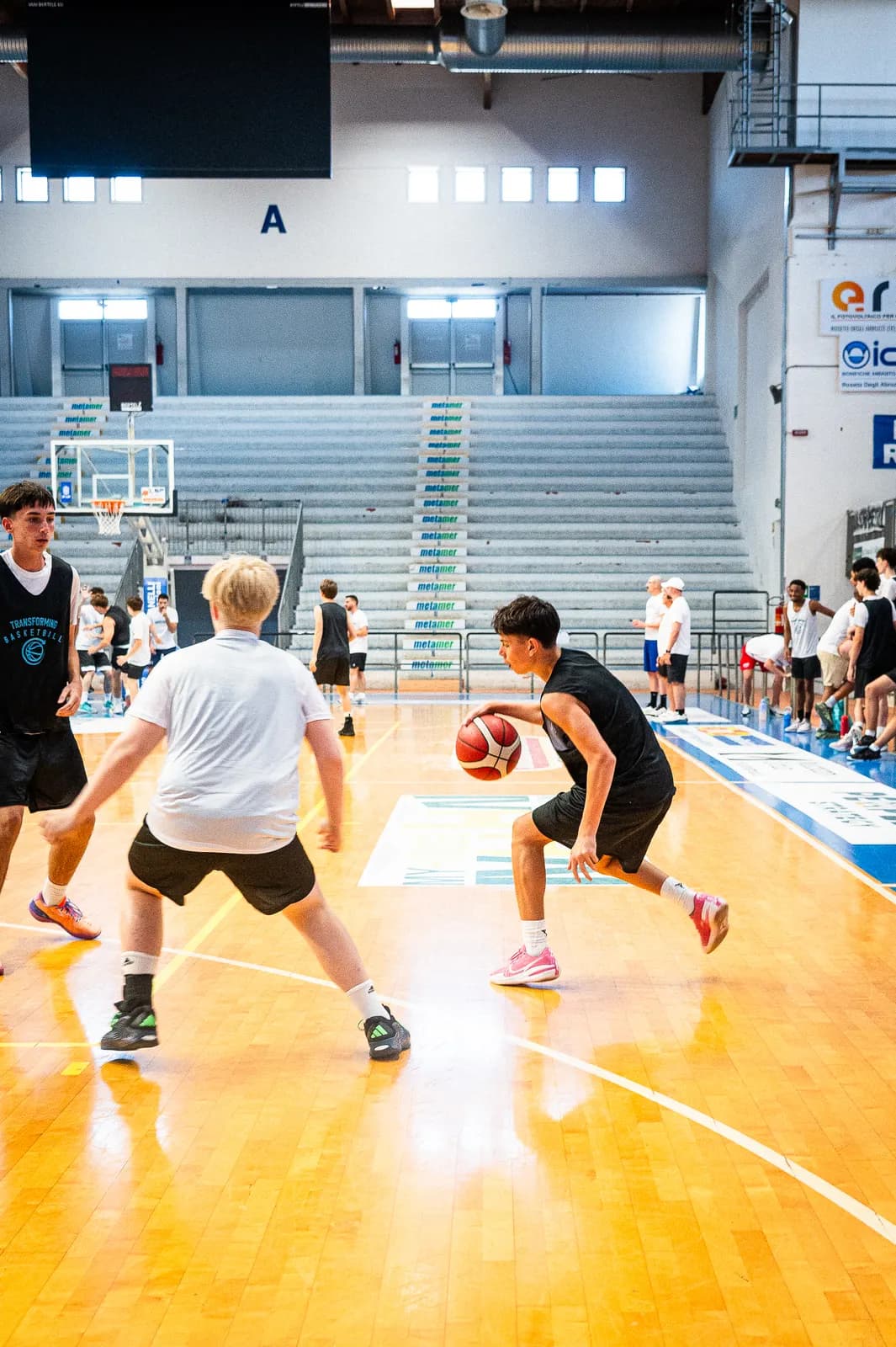 A guard attacking a defender off the dribble at the 2026 Transforming Basketball camp in Roseto