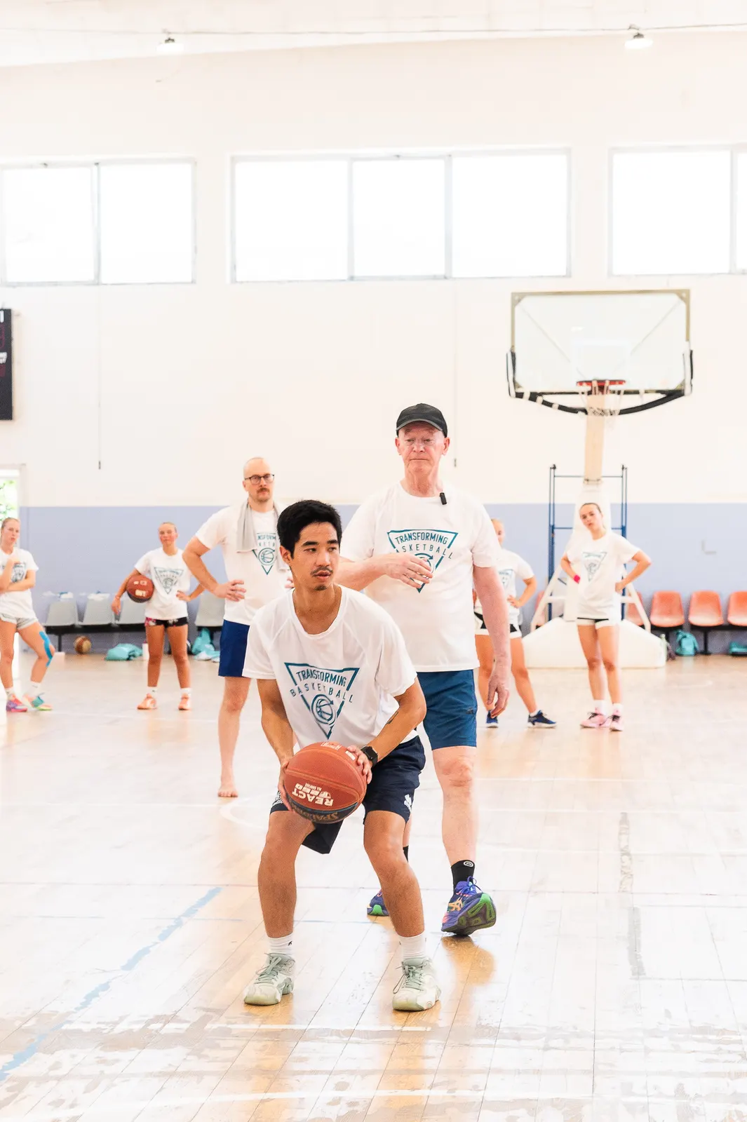A player in a ready stance during live play at the 2026 Transforming Basketball camp in Roseto