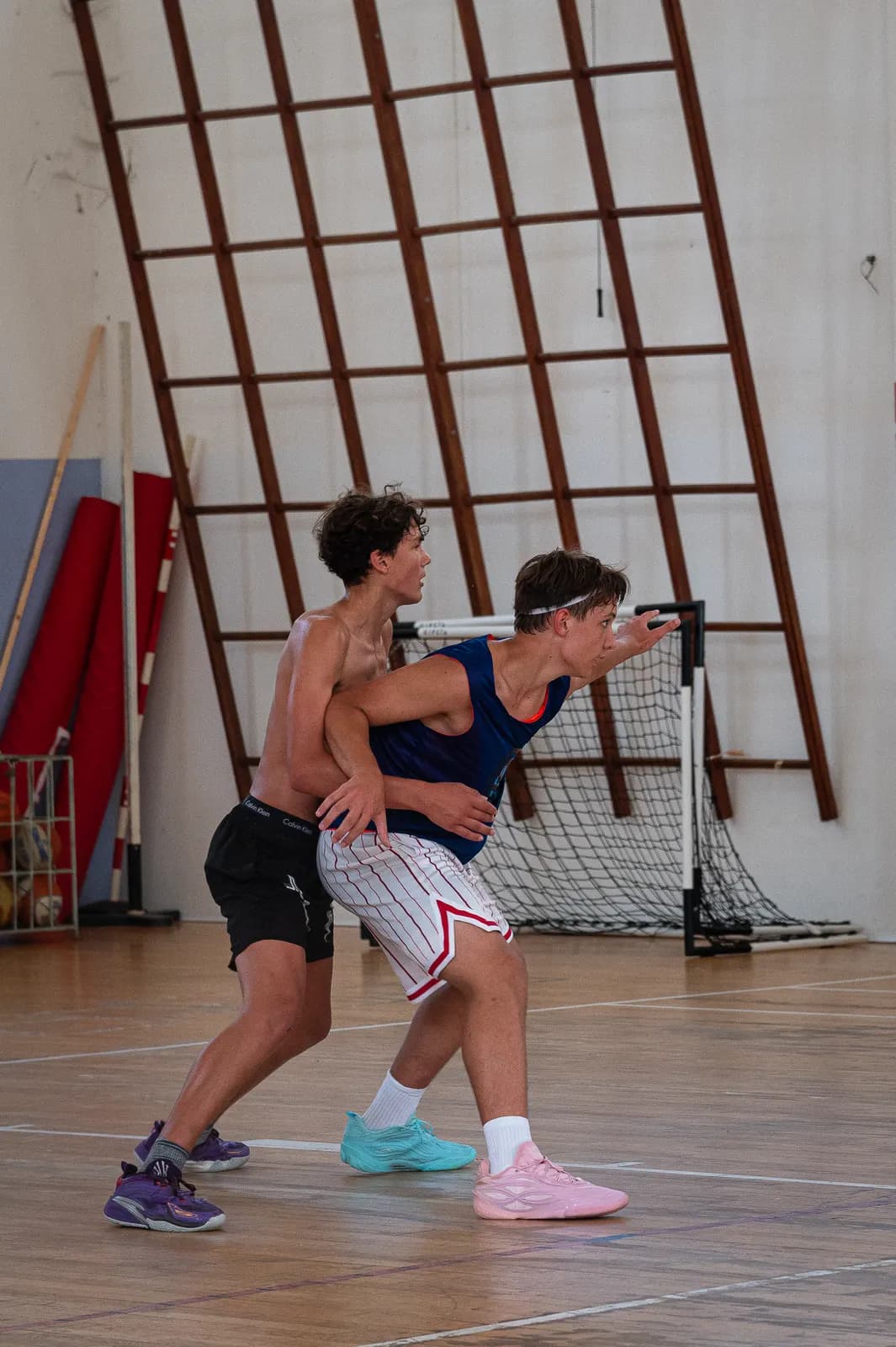 Players battling for position inside the paint during a live game at the 2026 Transforming Basketball camp in Roseto
