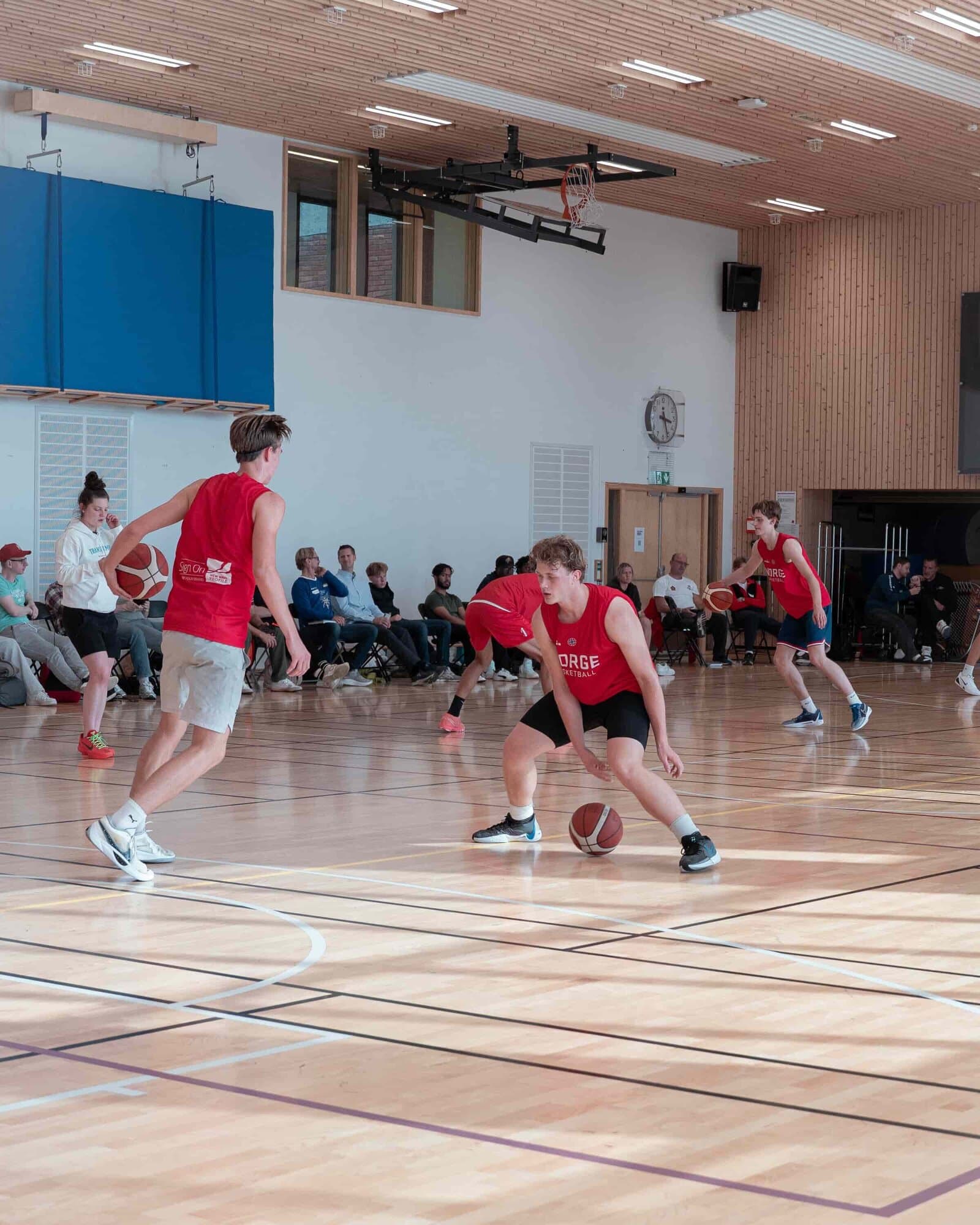 Players competing on court at a Transforming Basketball camp